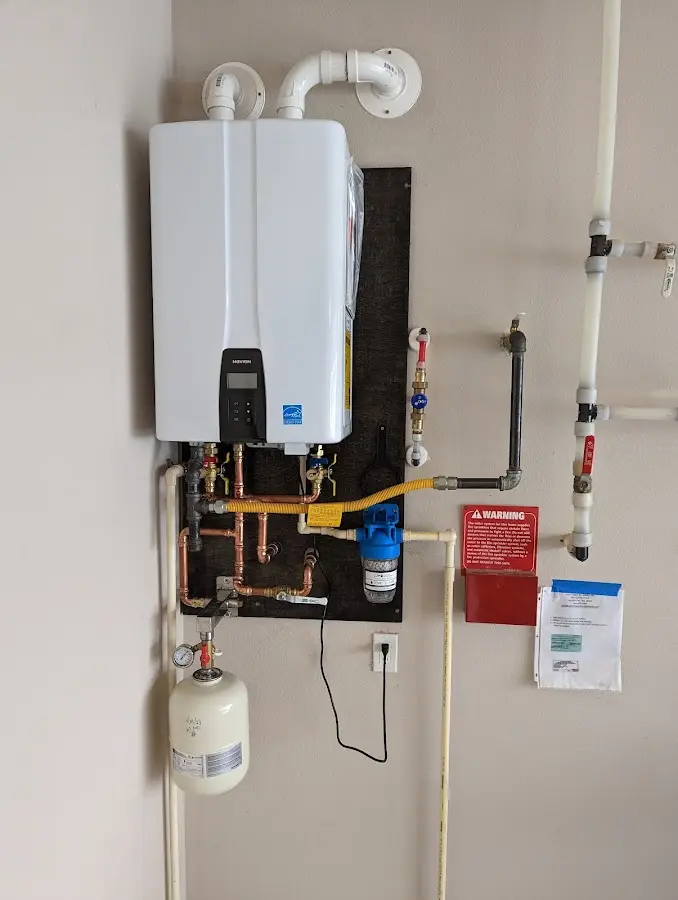 Professional plumber installing copper piping in a Hillandale home